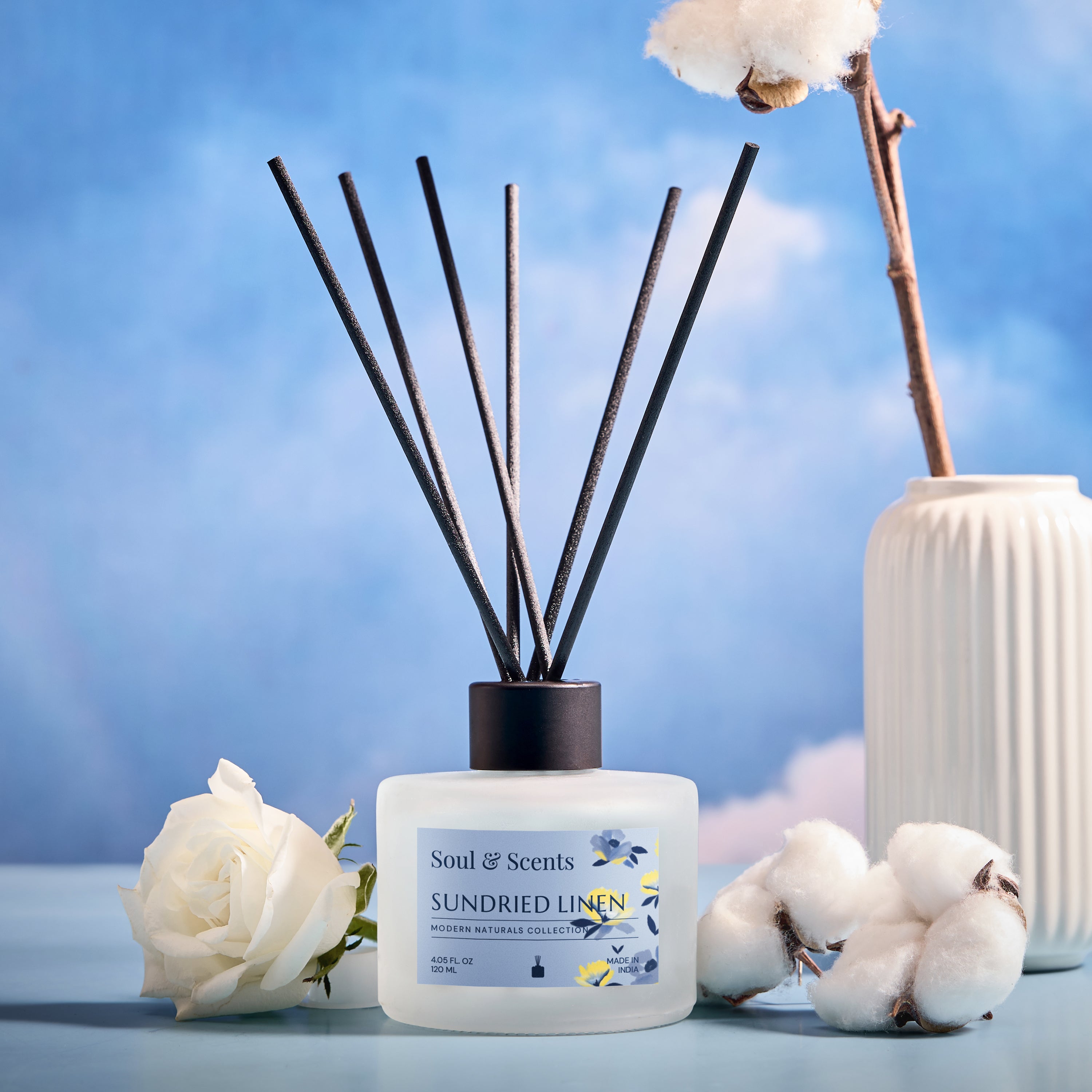 Scented diffuser bottle labeled 'Sundried Linen' with decorative elements on a blue background