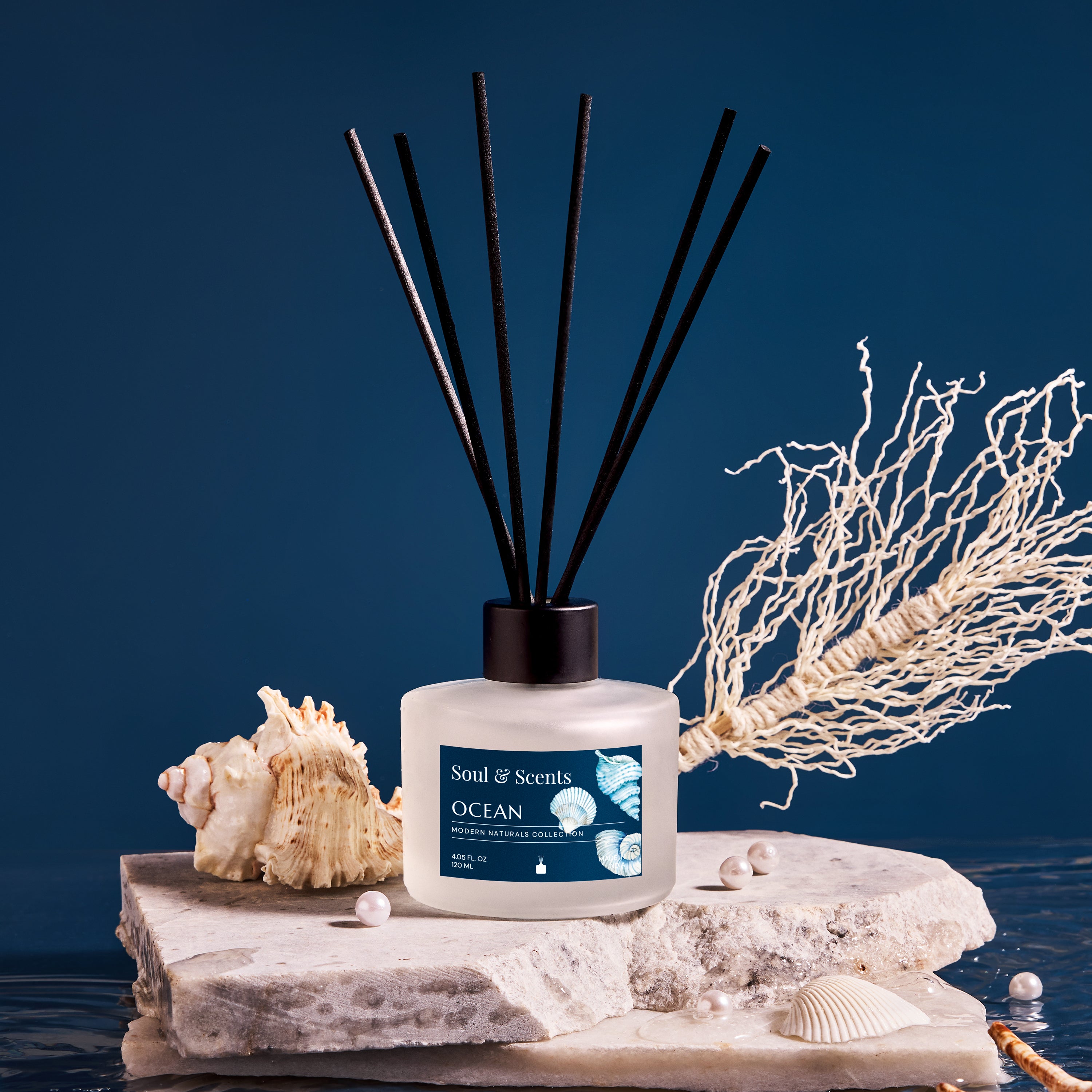 Scented diffuser labeled 'Ocean' with decorative elements on a blue background