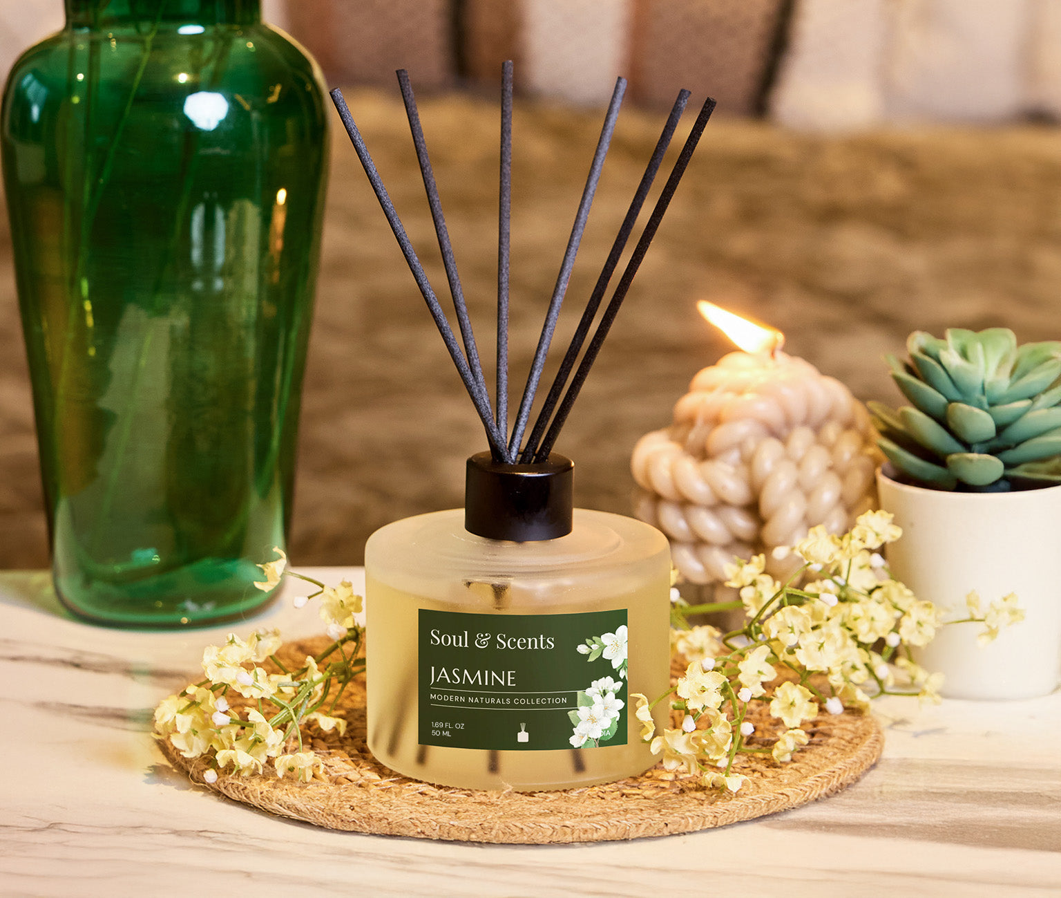 Scented diffuser labeled 'Soul Scents Jasmine' on a table with decorative items.