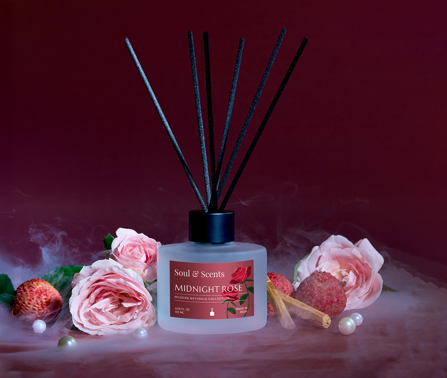 Soul & Scents Midnight Rose diffuser with roses and strawberries on a dark background