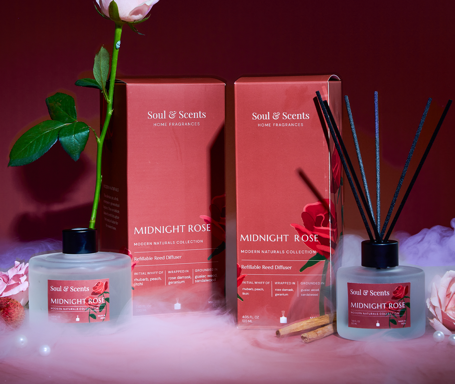Soul & Scents Midnight Rose fragrance set with diffuser, candles, and packaging on a red background.