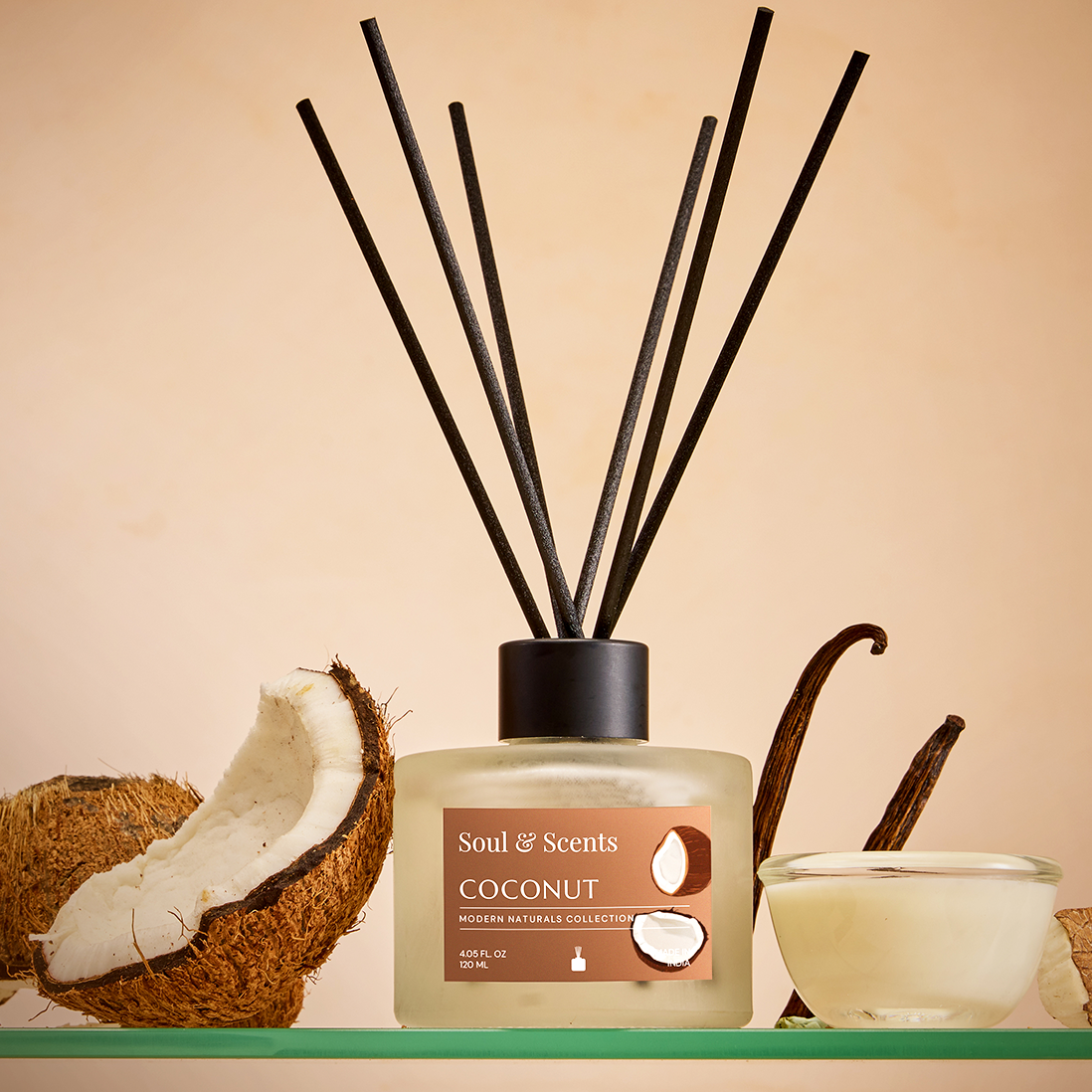 Soul & Scents coconut diffuser with coconut shell, vanilla bean, and candle on a beige background