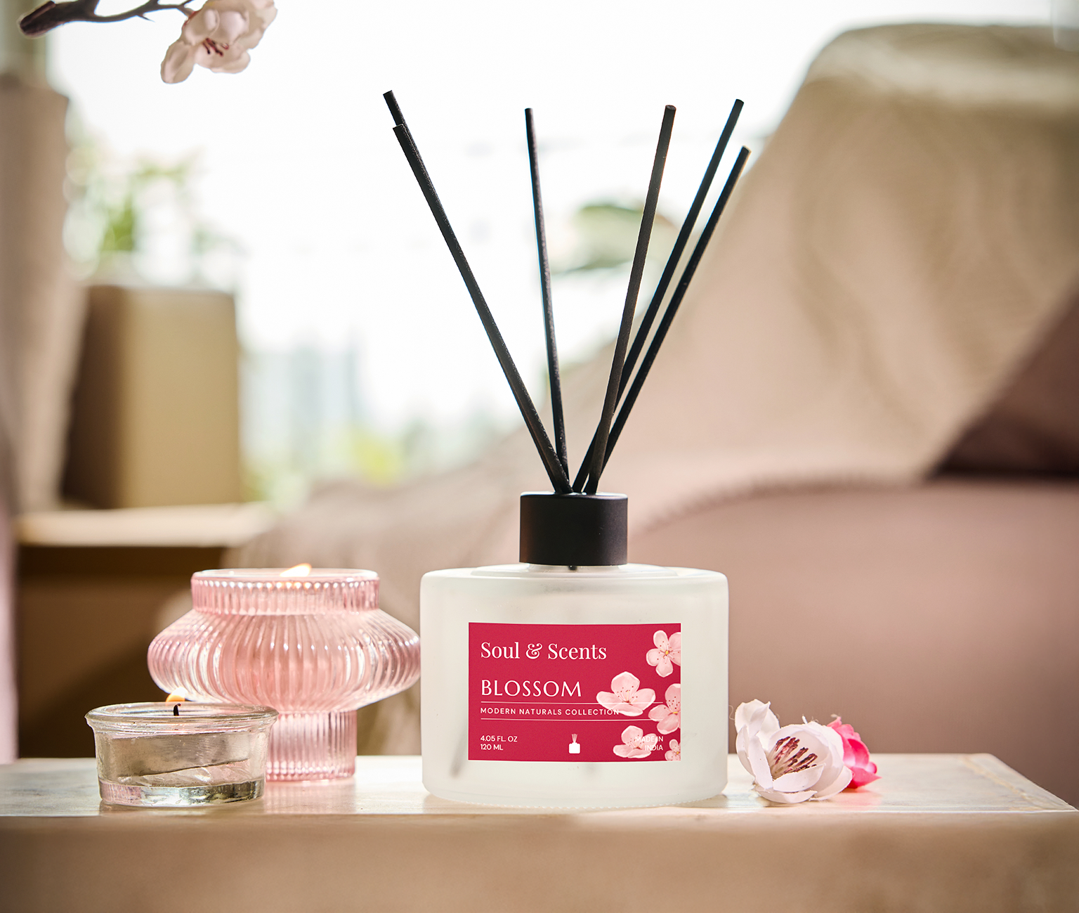 Scented diffuser with reeds and decorative elements on a table
