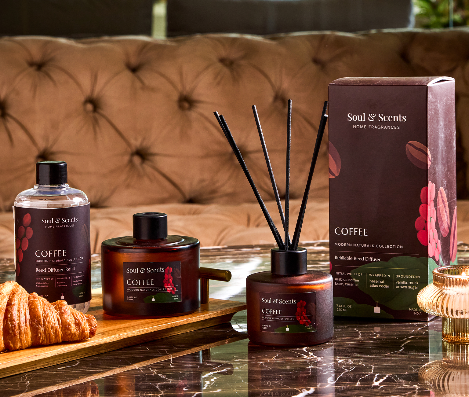 Soul & Scents coffee-themed home fragrance products on a table with a couch in the background.